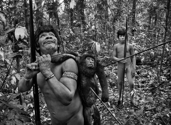 Two Amazonian male Indians in a hunting scene in the Amazon Forest.